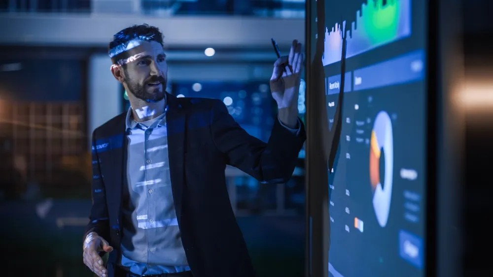 Man analyzing marketing channel measurements on a digital display.